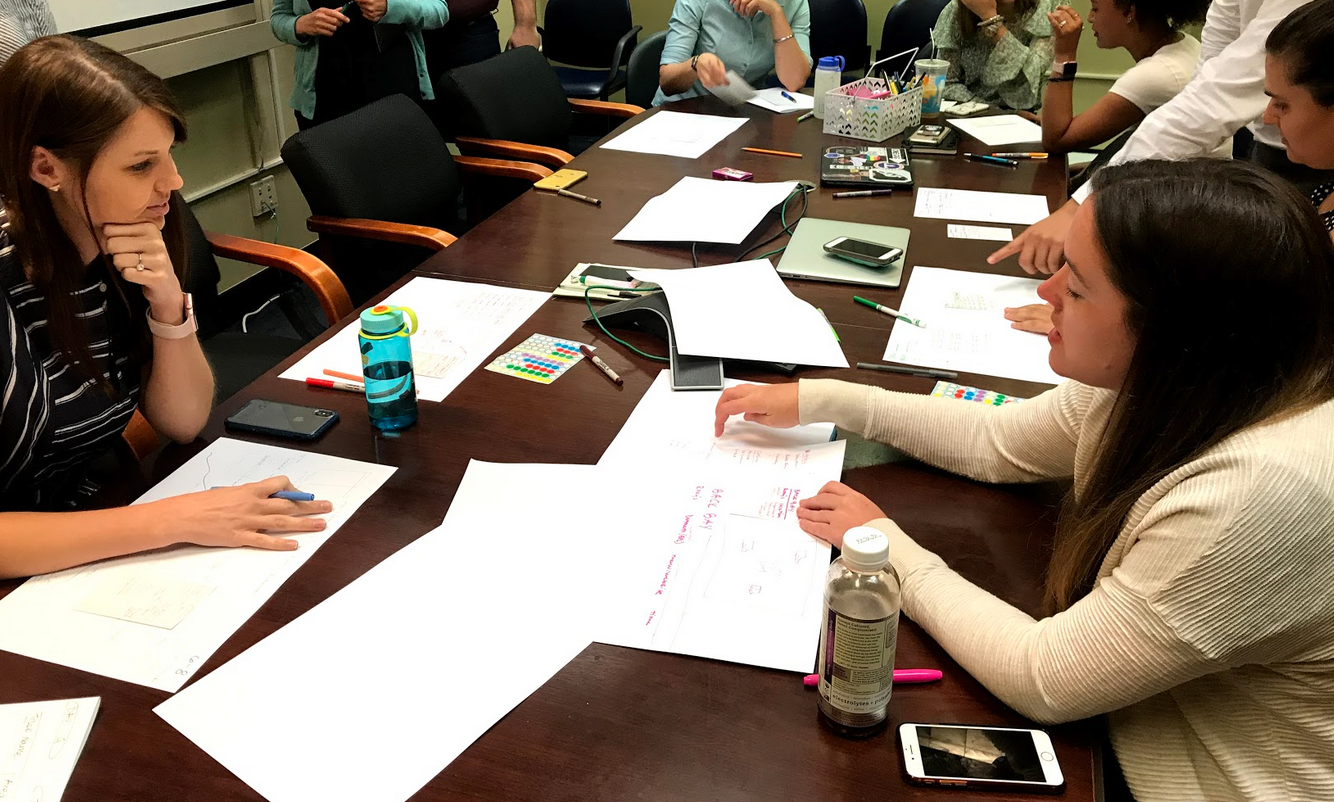 A participant pitching their sketch to the group